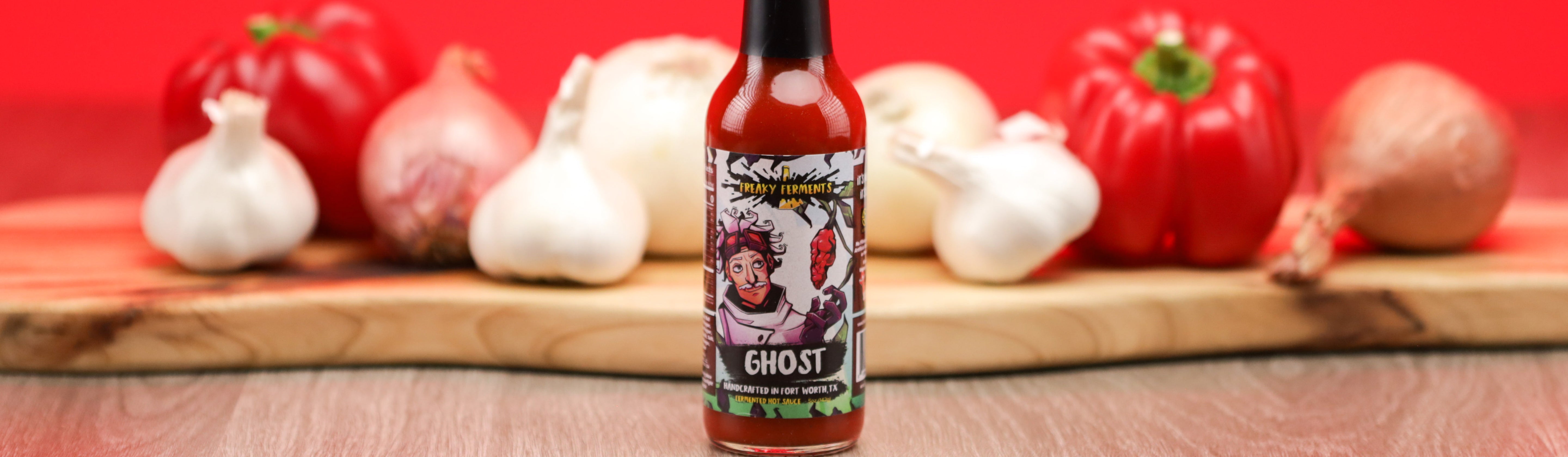 photo of a bottle of Ghost sauce in front of ingredients