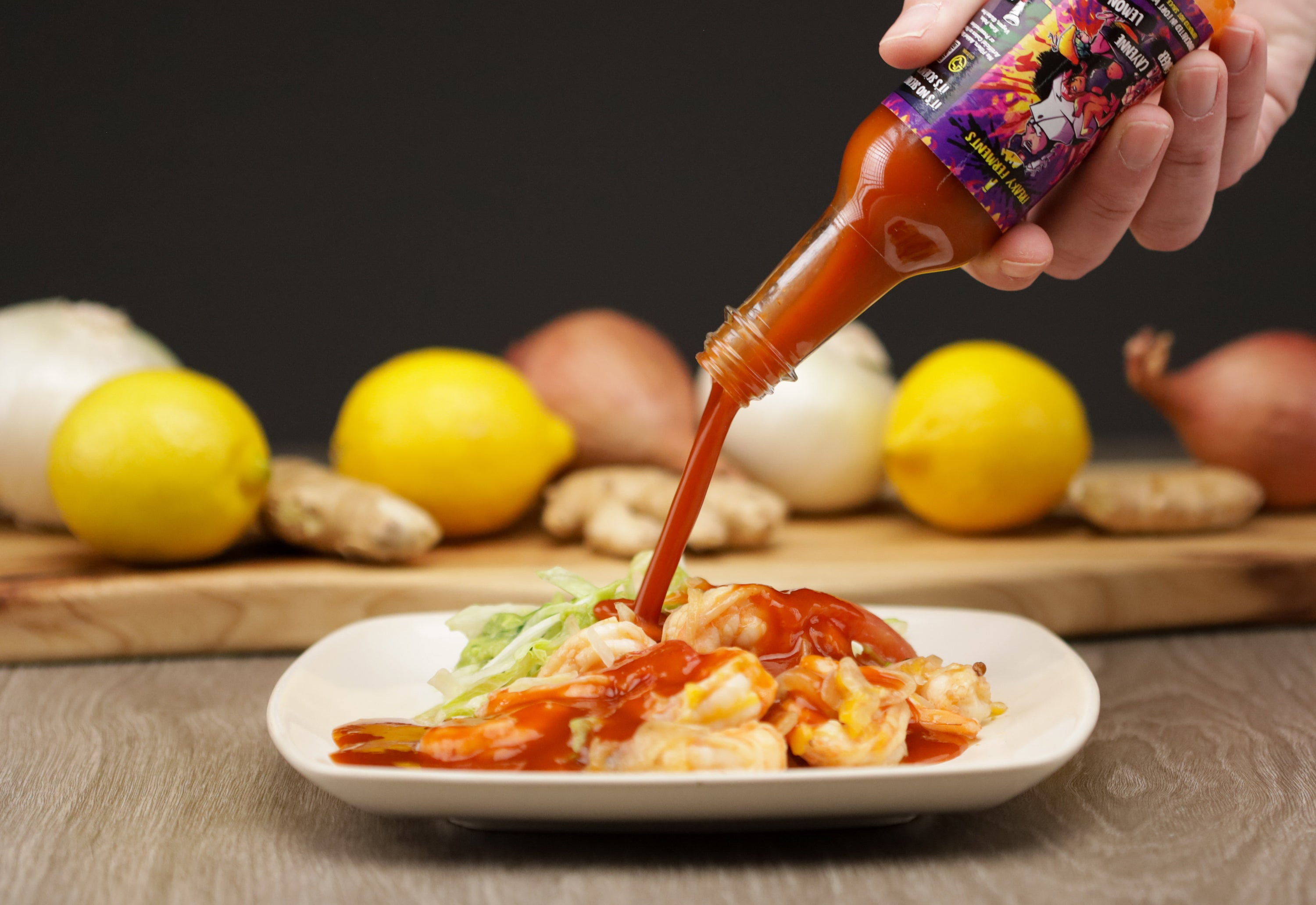 photo of a bottle of Ginger Cayenne Lemon being poured onto shrimp