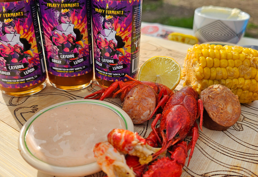 photo of bottled of Ginger Cayenne Lemon next to a crawfish