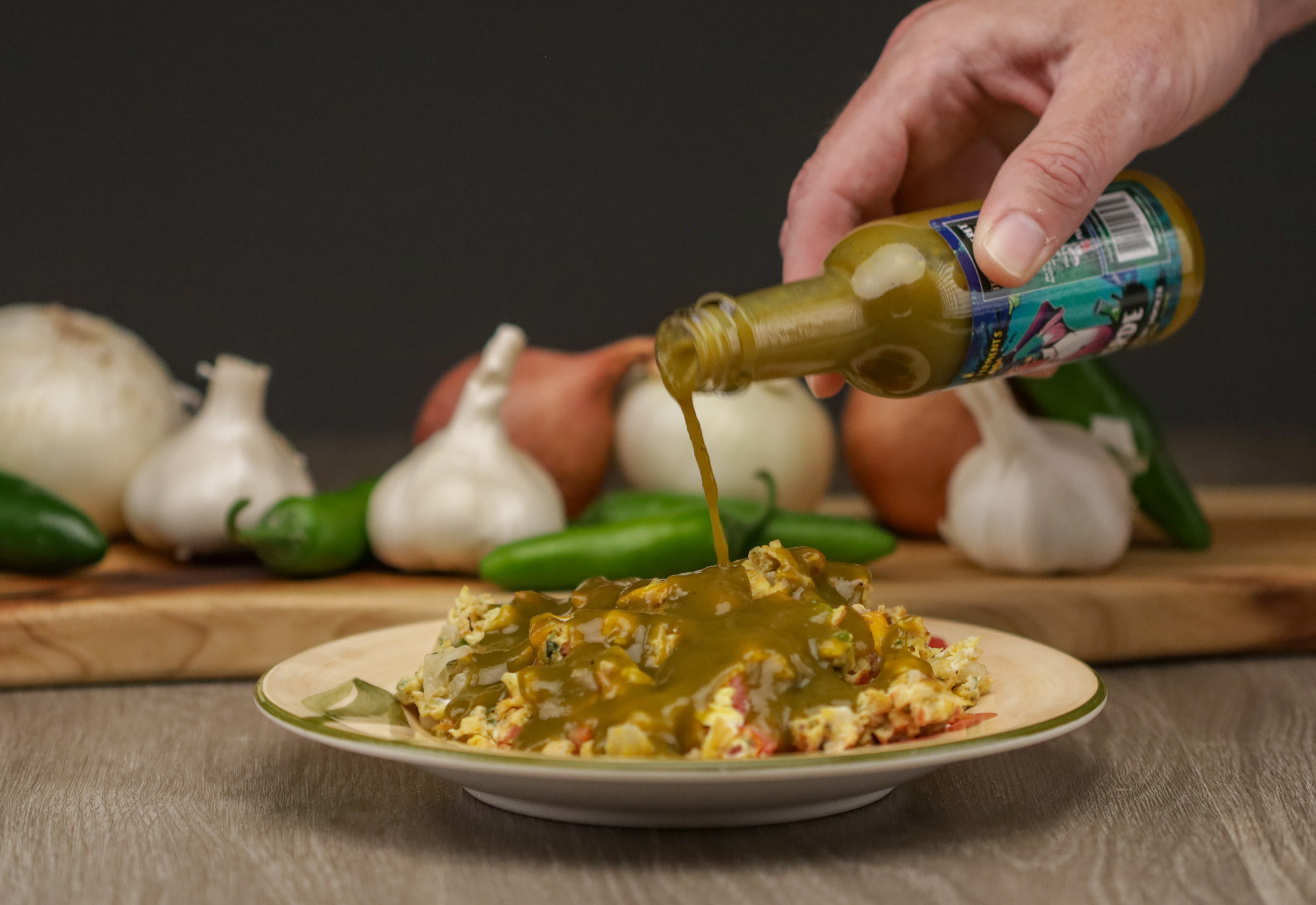 photo of a bottle of Verde being poured on eggs