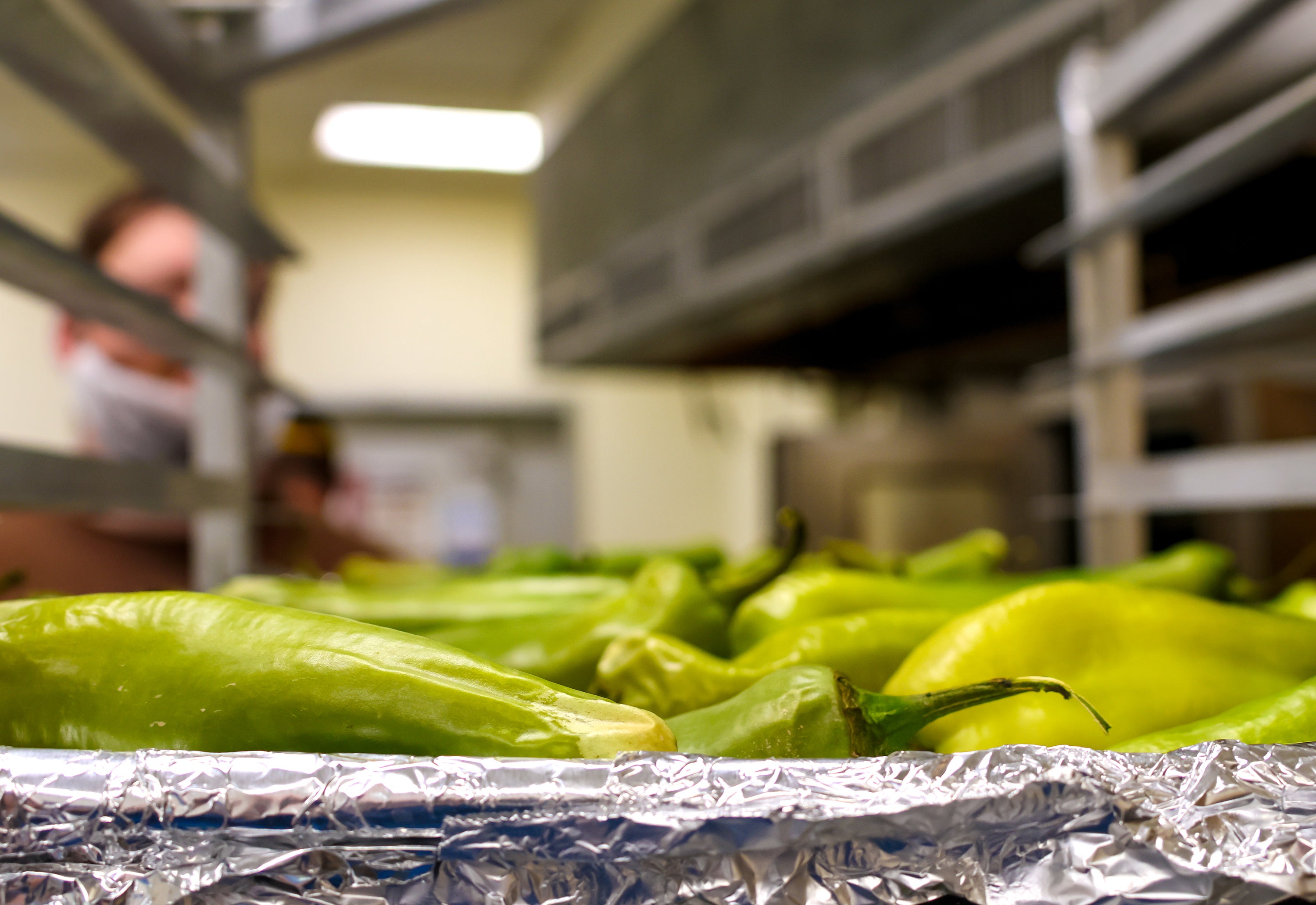 photo of roasted Anaheim peppers in rack for Verde sauce